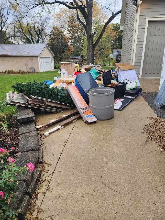 Dumpster being loaded with debris for Estate Cleanout Dumpster Rental in Munster